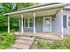 Front porch of a charming home, with classic columns and a welcoming entrance at 42 E Brookville Rd, Fountaintown, IN 46130