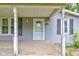 Close-up of a home's porch showcasing columns and a white trimmed front door at 42 E Brookville Rd, Fountaintown, IN 46130