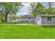 Backyard view with a one-car garage and well-maintained lawn at 42 E Brookville Rd, Fountaintown, IN 46130