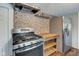 Updated kitchen features stainless steel appliances, stylish backsplash, and butcher block countertop at 42 E Brookville Rd, Fountaintown, IN 46130