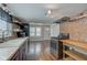 Spacious kitchen with updated appliances, dark cabinets, floating wood shelves and ample counter space at 42 E Brookville Rd, Fountaintown, IN 46130