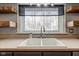 View of a double-basin kitchen sink and window flanked by open wood shelving at 42 E Brookville Rd, Fountaintown, IN 46130