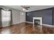 Bright living room with hardwood floors, a decorative fireplace, and a large window with natural light at 42 E Brookville Rd, Fountaintown, IN 46130