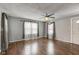 Living room with hardwood floors, gray walls, ceiling fan, and abundant natural light at 42 E Brookville Rd, Fountaintown, IN 46130
