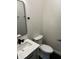 Modern bathroom with a white vanity, matte black fixtures, and neutral-colored walls at 44 S Butler Ave, Indianapolis, IN 46219