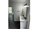 Bathroom featuring double sink vanity with white cabinets and black hardware with modern lighting and dark floors at 44 S Butler Ave, Indianapolis, IN 46219