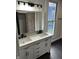 Bathroom featuring a modern vanity with dual sinks and quartz countertops at 44 S Butler Ave, Indianapolis, IN 46219