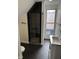 This bathroom features unique shower tile, and a single sink with dark wood floors for a modern feel at 44 S Butler Ave, Indianapolis, IN 46219
