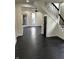 Spacious entryway featuring dark hardwood floors, stairs, and modern trim at 44 S Butler Ave, Indianapolis, IN 46219