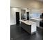 Modern kitchen with a large island, white cabinets, stainless steel appliances, and dark hardwood floors at 44 S Butler Ave, Indianapolis, IN 46219