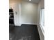 Bright kitchen area featuring dark hardwood floors, white cabinets, and stainless steel appliances at 44 S Butler Ave, Indianapolis, IN 46219