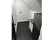 This laundry area features sleek black flooring, modern sink, and a compact refrigerator for added convenience at 44 S Butler Ave, Indianapolis, IN 46219
