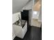This laundry area features sleek black flooring, modern sink and a compact refrigerator for added convenience at 44 S Butler Ave, Indianapolis, IN 46219
