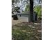 View of a shed with gray block walls and a tree in front at 44 S Butler Ave, Indianapolis, IN 46219