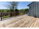 Wooden back deck with lush green view and a blue outdoor chair at 5077 Vantage Point Rd # 1 Wm-5-1, Avon, IN 46123