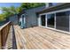 Large outdoor deck with wooden floors and railing with sliding glass doors at 5077 Vantage Point Rd # 1 Wm-5-1, Avon, IN 46123