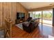 Comfortable living room with hardwood floors and sliding glass doors to the balcony at 5077 Vantage Point Rd # 1 Wm-5-1, Avon, IN 46123