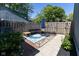 Private patio featuring a seating area with a blue rug, wooden fence and accent plants at 5077 Vantage Point Rd # 1 Wm-5-1, Avon, IN 46123