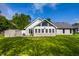 Backyard features well maintained grass, an exterior shed, blue Adirondack chair and the addition on the house at 51 Glasgow Ln, Noblesville, IN 46060