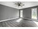 Spacious bedroom with plush carpet, neutral gray walls, two windows, and a ceiling fan at 51 Glasgow Ln, Noblesville, IN 46060