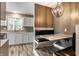 Cozy dining nook with a built-in banquette, marble table, stylish pendant light, and grey accent wall at 51 Glasgow Ln, Noblesville, IN 46060