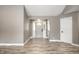 Bright entryway featuring wood-look flooring, gray walls, a white door, and modern recessed lighting at 51 Glasgow Ln, Noblesville, IN 46060