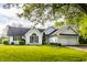 Inviting two-story home featuring a lush green lawn, arched window, and an attached two-car garage at 51 Glasgow Ln, Noblesville, IN 46060