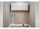 Laundry room features white cabinetry, vinyl floors, utility connections, and access to a closet at 51 Glasgow Ln, Noblesville, IN 46060