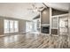Open living room with vaulted ceiling, fireplace, built-in shelving, and access to the dining area at 51 Glasgow Ln, Noblesville, IN 46060