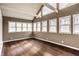 Spacious sun room with hardwood floors, a high ceiling, and multiple windows offering ample natural light at 51 Glasgow Ln, Noblesville, IN 46060