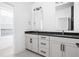 Elegant bathroom featuring double vanity with dark countertops and modern fixtures and plenty of space at 525 Fynn Pl, Indianapolis, IN 46202