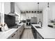 Bright, modern kitchen featuring stainless steel appliances, an island with a sink, and contrasting countertops at 525 Fynn Pl, Indianapolis, IN 46202