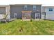 Large backyard features green grass, patio, decorative pergola and white fencing at 5256 Bramwell Ln, Whitestown, IN 46075