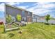 Expansive backyard featuring a manicured lawn, garden boxes, privacy fence, and mature trees at 5256 Bramwell Ln, Whitestown, IN 46075