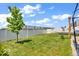 Well-maintained backyard features a tree, green grass, and white vinyl privacy fence at 5256 Bramwell Ln, Whitestown, IN 46075