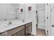 Bathroom featuring a double vanity with dark cabinets, tiled floors, and a separate tub and shower area at 5256 Bramwell Ln, Whitestown, IN 46075