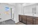 Bathroom features a glass enclosed shower, hexagon tile floor, and double vanity with a large mirror at 5256 Bramwell Ln, Whitestown, IN 46075