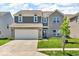 Charming two-story home with a well-manicured lawn and a two-car garage at 5256 Bramwell Ln, Whitestown, IN 46075