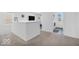 Hallway view features neutral carpet, white walls, and access to the laundry room at 5256 Bramwell Ln, Whitestown, IN 46075
