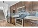 Modern kitchen with stainless steel appliances, granite countertops, a gray backsplash, and abundant cabinet space at 5256 Bramwell Ln, Whitestown, IN 46075
