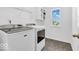 Functional laundry room with modern washer and dryer, white cabinets and hexagon tile flooring at 5256 Bramwell Ln, Whitestown, IN 46075