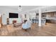 Open-concept living space with a view of the kitchen, modern decor, and seamless flow throughout the home at 5256 Bramwell Ln, Whitestown, IN 46075