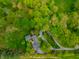 Birds eye view of a home showcasing beautiful landscaping, a winding driveway, and mature trees at 5356 S U.S. Highway 421, Zionsville, IN 46077