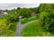 Stunning aerial view of a brick home featuring lush landscaping and a long, winding driveway at 5356 S U.S. Highway 421, Zionsville, IN 46077