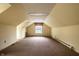 Attic featuring a window, carpet, and sloped ceilings at 5356 S U.S. Highway 421, Zionsville, IN 46077