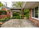 Back patio with manicured landscaping including an arbor, mature shrubs, and blooming flower beds at 5356 S U.S. Highway 421, Zionsville, IN 46077