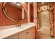 Bathroom featuring a vanity with a mirror, tiled walls, and a shower-tub combination at 5356 S U.S. Highway 421, Zionsville, IN 46077