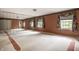 Large bedroom with plush carpet, mirrored wall, three large windows, and floral valances at 5356 S U.S. Highway 421, Zionsville, IN 46077