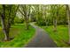 Long, winding driveway leads through a serene landscape with mature trees and lush greenery at 5356 S U.S. Highway 421, Zionsville, IN 46077