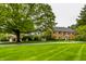 Brick home with lush green lawn and mature trees creates a charming curb appeal at 5356 S U.S. Highway 421, Zionsville, IN 46077
